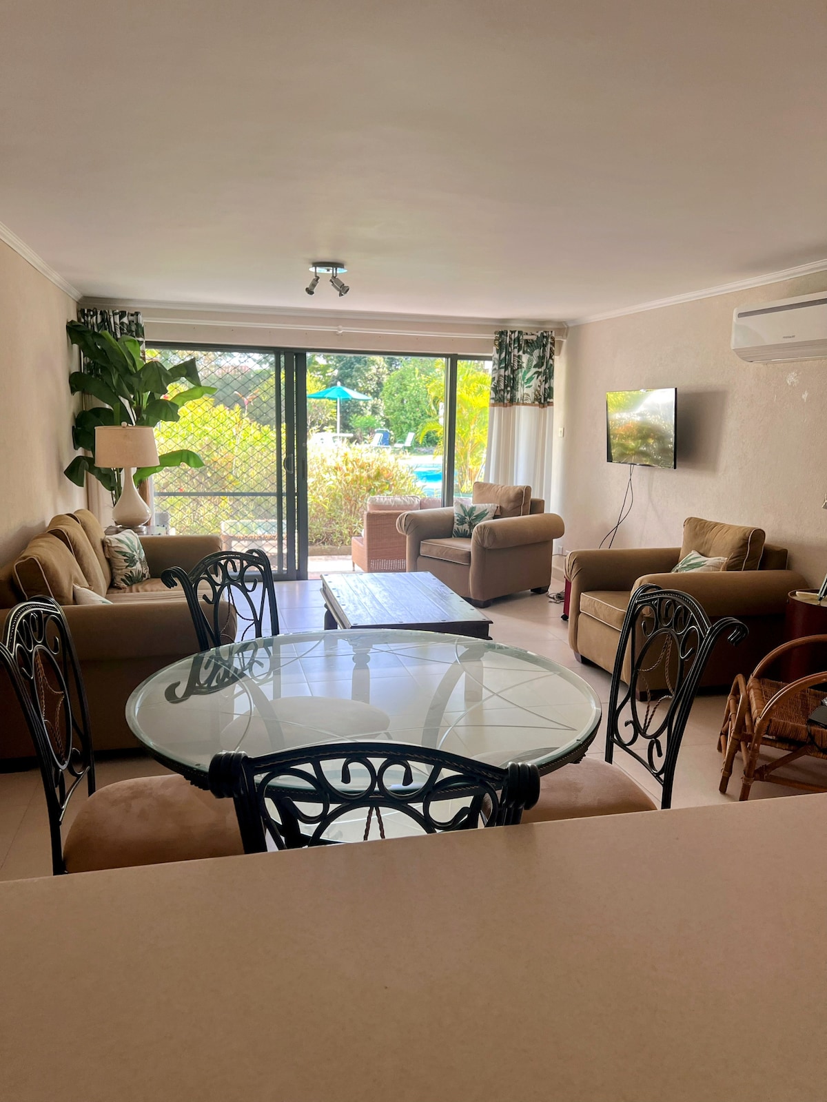 Living and dining area with pool view